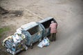 KYIV, UKRAINE MARCH 31, 2019: A homeless man looking for food in a garbage dumpster. Urban Poverty