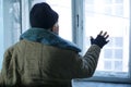 Homeless man is looking out of the window Royalty Free Stock Photo