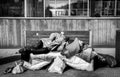 Homeless man, Poor homeless man or refugee sleeping on the wooden bench on the urban street in the city with bags of clothes and j Royalty Free Stock Photo