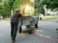 A homeless man pushes a cart in front of him Royalty Free Stock Photo