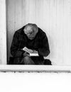 Homeless man reading a book