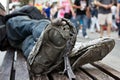 Homeless manÃÂ´s rotten shoes with dirty feet on urban environment Royalty Free Stock Photo