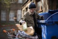 Homeless man searching for empty bottles and other stuff for recycle. Royalty Free Stock Photo