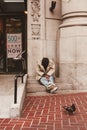 Homeless man sitting outside a shopping mall, San Francisco, California, united States of America aka USA Royalty Free Stock Photo