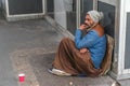 Homeless man sitting on the street Royalty Free Stock Photo