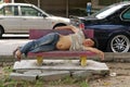 Homeless man sleep on bench on urban background. Beggar on street. Living on streets. Poverty. Helping those less Royalty Free Stock Photo