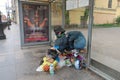 Homeless man sleeping at the bus stop