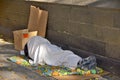 A homeless man sleeping beside central park wall Royalty Free Stock Photo