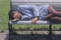 Homeless man sleeping on a park bench, Los Angeles, California