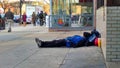 Homeless man sleeping on sidewalk