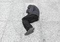 Homeless man sleeps on the ground in the city center Royalty Free Stock Photo