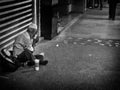 Homeless man taking his dinner in the street