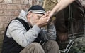 Homeless man taking a woman's hand