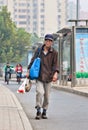 Homeless man walks on the street, Beijing, China Royalty Free Stock Photo