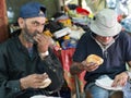 Homeless men eating