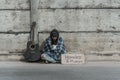 Homeless old man lost his home and was left alone with luggage sitting and sufferring at train station Royalty Free Stock Photo