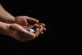 homeless outreach day. Dirty hands of a homeless man holding not much money against a black background. The concept of Royalty Free Stock Photo