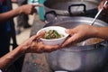 Homeless people are helped with food relief, famine relief : volunteers giving food to poor people in desperate need : The concept Royalty Free Stock Photo