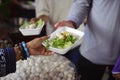 Homeless people are helped with food relief, famine relief : volunteers giving food to poor people in desperate need : The concept Royalty Free Stock Photo