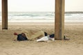 Homeless person sleeping on beach Royalty Free Stock Photo