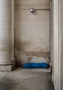 A homeless person sleeping beneath CCTV