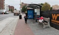 Homeless Person is Sleeping on the Bus Stop Bench in Baltimore, Maryland