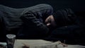 Homeless person sleeping on street, shelter for poor people, city panhandling Royalty Free Stock Photo