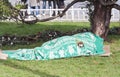 Homeless person sleeping under blanket in park Royalty Free Stock Photo