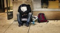 Homeless Person Begging On A Dirty Urban Street in Large City