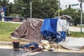 Homeless person tent camp at the edge of a busy Kroger shopping center on Memorial Dr