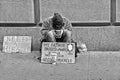 21.05.2016. Homeless poor person in front of Wall Street Stock Excange building ask help and money in Manhattan, New York City, US