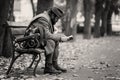 A homeless reading on a bench