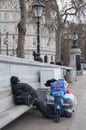 Homeless sleeps on a stone bench in Trafalgar Square Royalty Free Stock Photo