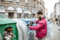Homeless beggar near the trash containers in the city Royalty Free Stock Photo