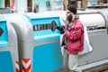 Homeless beggar near the trash containers in the city Royalty Free Stock Photo