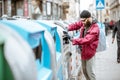 Homeless beggar near the trash containers in the city Royalty Free Stock Photo