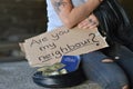 Homeless woman begging for money holding a sign Royalty Free Stock Photo