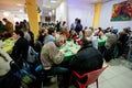 Homeless and unhealthy people eat food at the Christmas charity dinner for the homeless Royalty Free Stock Photo