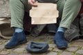 homeless woman man begging with cardboard  in the street Royalty Free Stock Photo