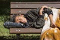 Homeless woman sleeping on a bench Royalty Free Stock Photo