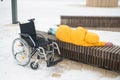 Homeless woman sleeping on a park bench next to a wheelchair. Royalty Free Stock Photo