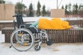 Homeless woman sleeping on a park bench next to a wheelchair. Royalty Free Stock Photo