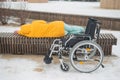 Homeless woman sleeping on a park bench next to a wheelchair. Royalty Free Stock Photo