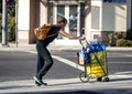 A Homeless woman walking on city street with her belongings in santa ana ca