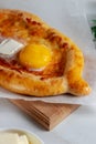 Homemade Adjarian khachapuri with sulguni cheese and egg yolk and Butter.Traditional Georgian cuisine