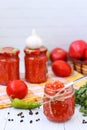 Homemade adzhika with apples in jars on a white background Royalty Free Stock Photo