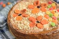 Homemade air-nut cake with chocolate cream, boiled condensed milk, candied fruit, nuts and dried apricot on grey wooden background Royalty Free Stock Photo