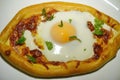 Homemade Ajarian khachapuri with cheese and egg. Handmade, cooking healthy food with your own hands at home