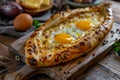 Homemade Ajarian Khachapuri with Sulguni Cheese Filled with a Raw Egg and Melted Butter Close Up