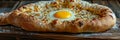 Homemade Ajarian Khachapuri with Sulguni Cheese Filled with a Raw Egg and Melted Butter Close Up